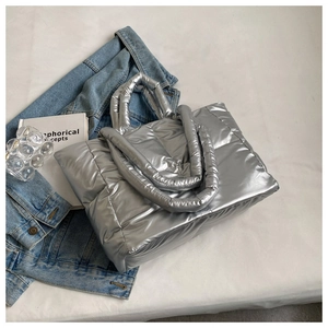 Detailed top view of a silver quilted puffer tote bag with metallic waterproof finish