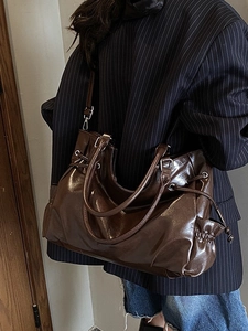 Vintage dark brown gloss tote bag with side drawstring details and long shoulder strap