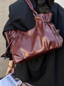 Vintage burgundy tote bag in shiny faux leather with drawstring detail and silver hardware