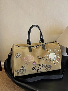 Large khaki canvas travel tote bag with colorful graffiti patterns and black handles