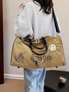 Graffiti canvas travel bag in khaki with leather straps and playful cartoon illustrations
