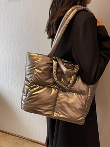 Quilted metallic bronze puffer tote bag with padded handles and large capacity
