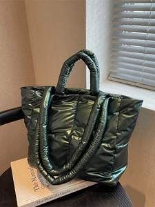 Green quilted down tote bag with dual handles for shoulder and hand carry