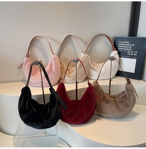 Selection of colorful plush hobo bags in pink, beige, black and burgundy on display