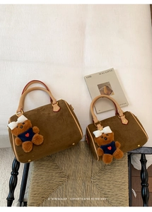 Two sizes of retro brown frosted Boston bags with cute bear charms on a textured background