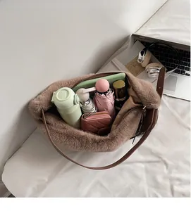 Interior view of brown plush dumpling bag showing large storage capacity for daily items