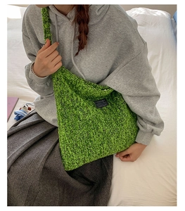 Detail van de groene fleece draagtas met fashion label gedragen door model
