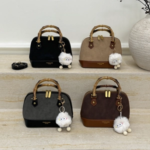 Minimalist shell handbag with bamboo handles and leopard print stitching in four colors
