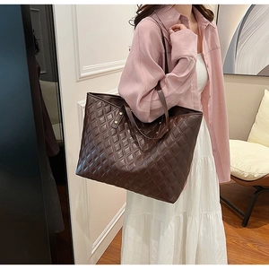 Detail of coffee brown quilted tote bag with large capacity for autumn and winter commute