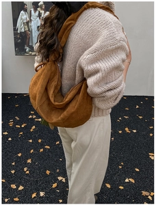 Detail of caramel suede hobo bag with large capacity and soft pleated texture