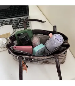Interior storage of the brown checkered hobo bag showing large capacity for essentials