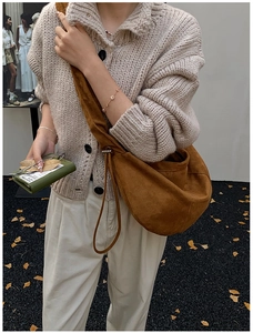Brown suede hobo bag styled with a beige knit cardigan for an autumn outdoor look