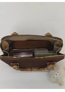 Detailed top view of leopard shell bag showing spacious interior with daily essentials