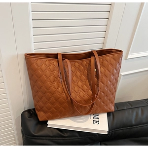 Detail of caramel tote bag showing quilted diamond pattern and high-quality PU leather
