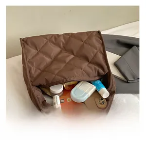 Interior view showing the large storage capacity of the dark brown quilted shoulder bag