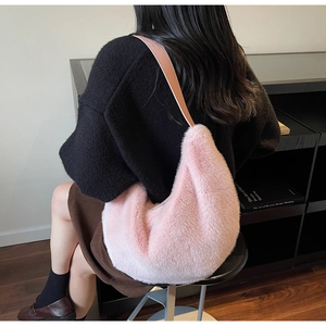 Detail of soft pink faux fur hobo bag with a stylish brown leather shoulder strap
