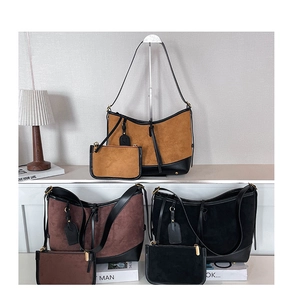 Detail of three oversized suede tote bags with matching small pouches and leather trim