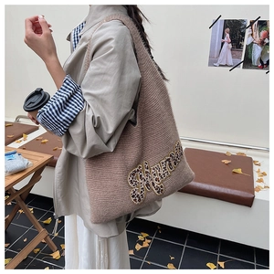 Detail of knit tote bag with leopard Mama embroidery in a casual outdoor setting