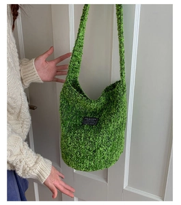 Detail der grünen flauschigen Plüschtasche mit schwarzem Fashion-Label auf der Front