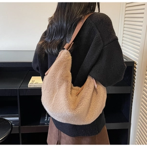 Detail of camel plush hobo bag with adjustable leather strap and fluffy faux fur texture