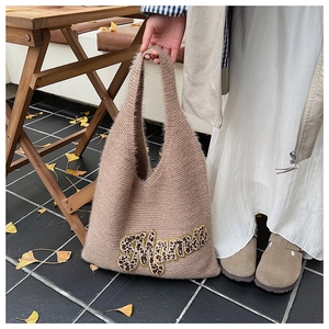 Close-up of knit tote bag featuring Mama leopard print appliqué and soft fuzzy texture
