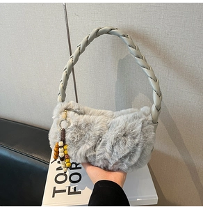 Detail of braided green handle and soft faux fur texture with bohemian beaded charm