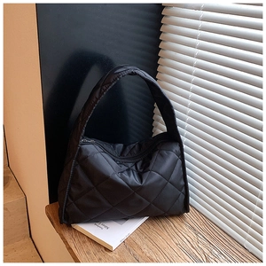 Detail shot of large quilted shoulder bag in black with premium stitching and zipper