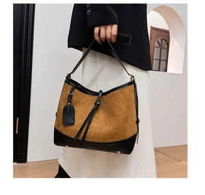Detail of vintage contrast color crossbody bag with fringe and suede leather texture