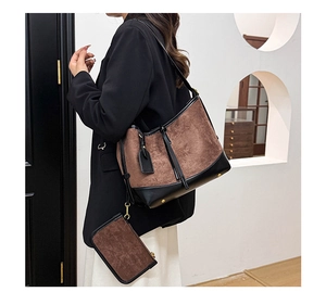 Detail of vintage brown suede and black leather patchwork bucket bag shown with inner pouch