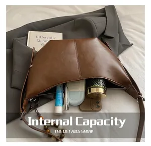 Detail showing the internal storage capacity of the dark brown hobo bag with daily essentials