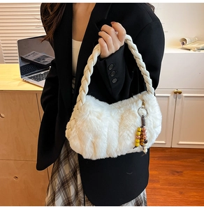 Detail of white plush handbag featuring a woven handle and colorful vintage wooden beads