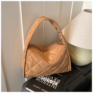 Detailed view of quilted caramel nylon shoulder bag featuring puffy diamond stitching textures