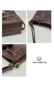 Vue détaillée du sac cabas marron avec boucles dorées, fermetures et coutures blanches