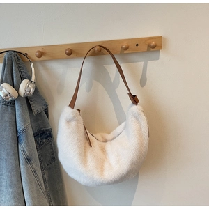 Detail of soft white faux fur shoulder bag with premium brown leather strap