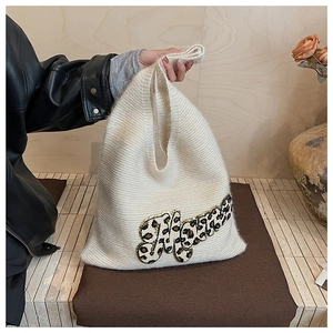 Close-up of white knitted tote bag with leopard print Mama letter patchwork detail