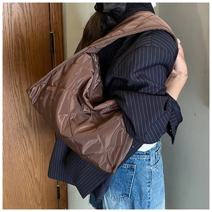 Detailed view of quilted brown nylon hobo bag with large capacity and stitched pattern