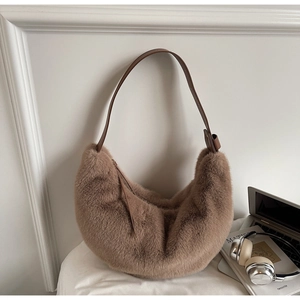 Close-up of fluffy brown hobo bag showing faux fur texture and dark leather strap