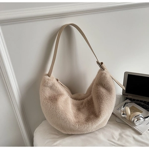 Close-up of beige plush faux fur hobo bag with adjustable leather shoulder strap