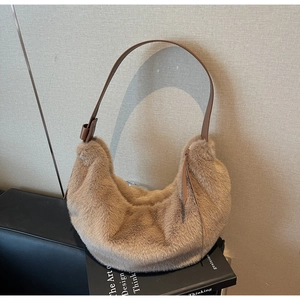 Detailed close-up of fluffy camel faux fur hobo bag with sleek brown leather strap
