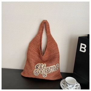 Close-up of the soft brown mohair texture and leopard print Mama embroidery on the tote bag