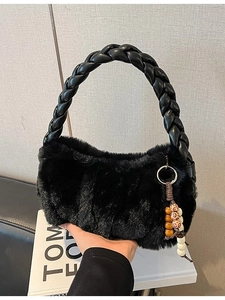 Fashionable black faux fur handbag with braided leather handle and ethnic beaded charm