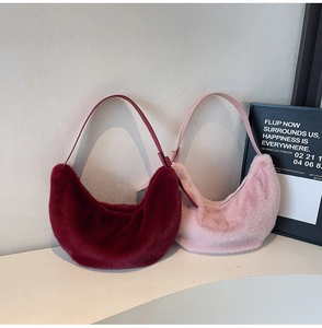 Close-up of plush hobo bags in dark red and pink with adjustable leather straps