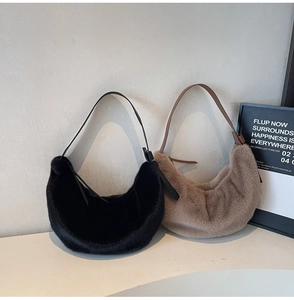 Detail of plush faux fur half-moon shoulder bags in black and light brown colors