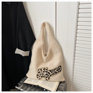 Detail of soft cream knit tote bag featuring leopard print Mama letter embroidery patch