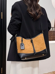 Retro contrast color suede shoulder bag with gold metal studs shown on model back