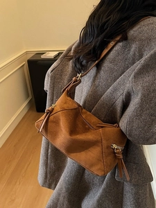 Retro caramel suede dumpling bag for women with adjustable strap and vintage fringe detail