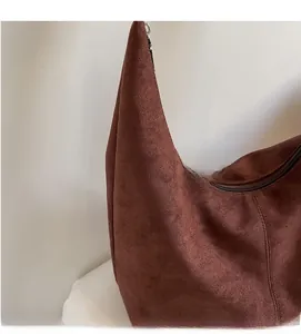Close-up of soft brown suede Hobo bag showing fine stitching and metal zipper texture