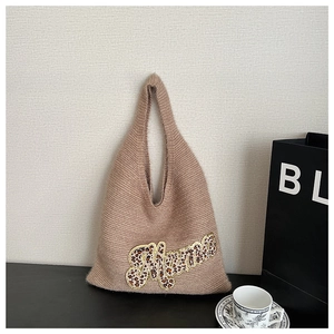 Detail of knitted tote bag with leopard print Mama letter embroidery and plush texture