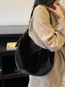 Chic black faux fur shoulder bag with leather strap and soft fluffy texture for winter