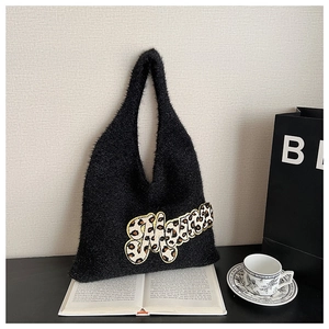 Detail of black knit tote bag with leopard print MARCH letter embroidery texture